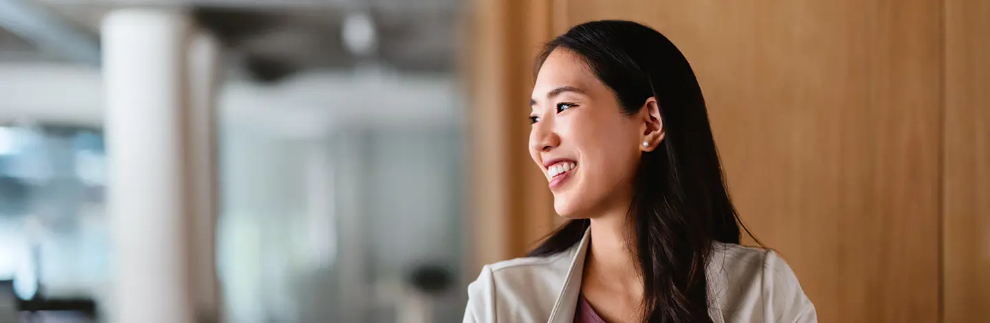 Asian woman smiling in an office