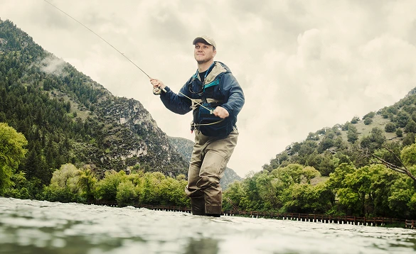 A man is holding a fishing rod