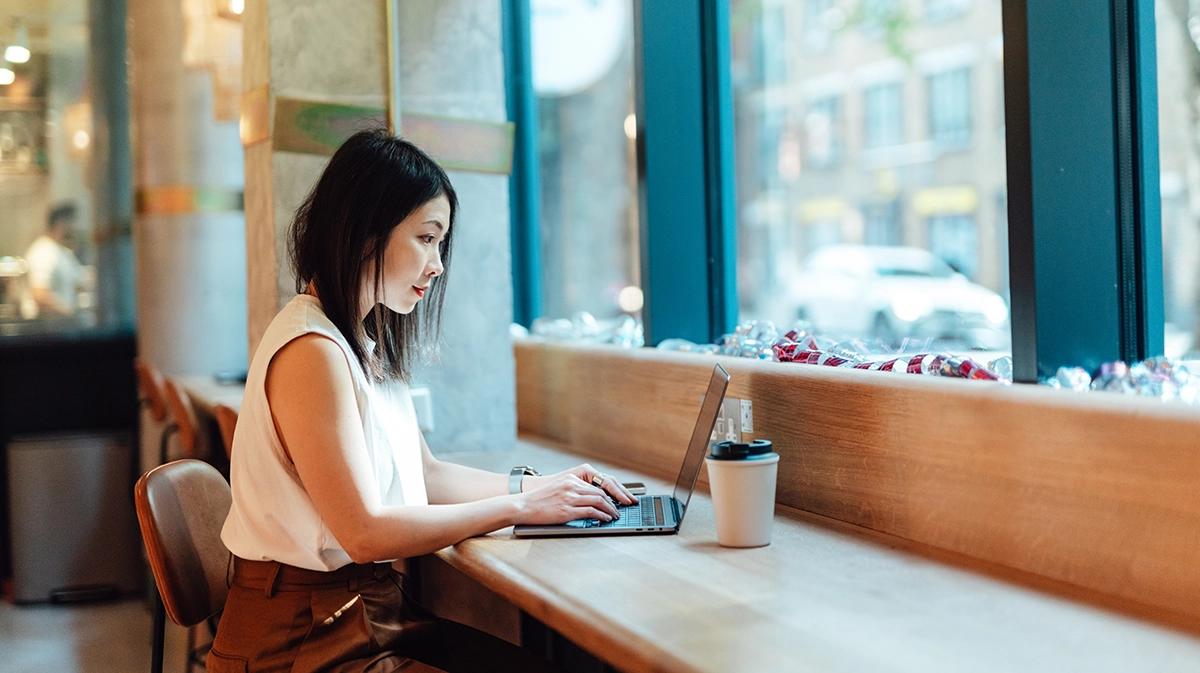 young asian woman working with laptop in coworking space