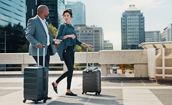 Couple of business people with luggage