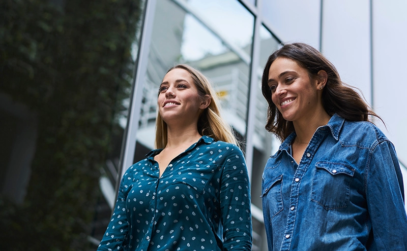 Two women walking with smile