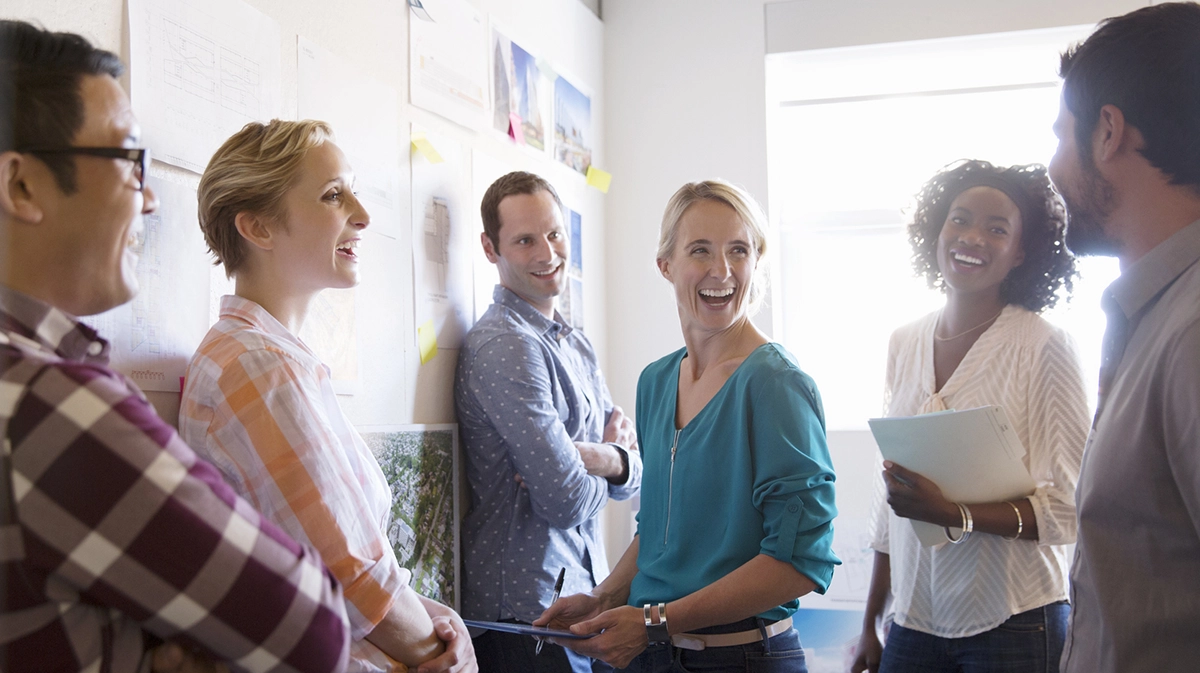 Team of colleagues standing and laughing