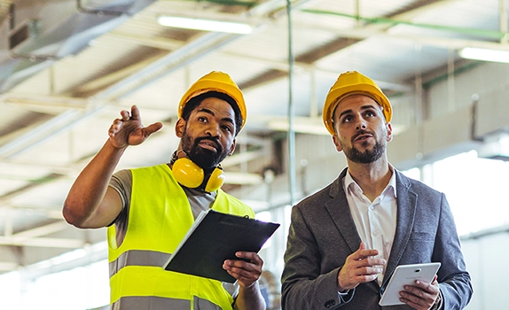 Two colleagues touring a warehouse