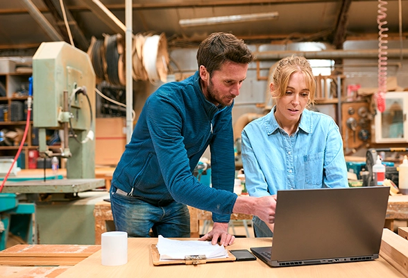 Two colleagues in a wood workshop