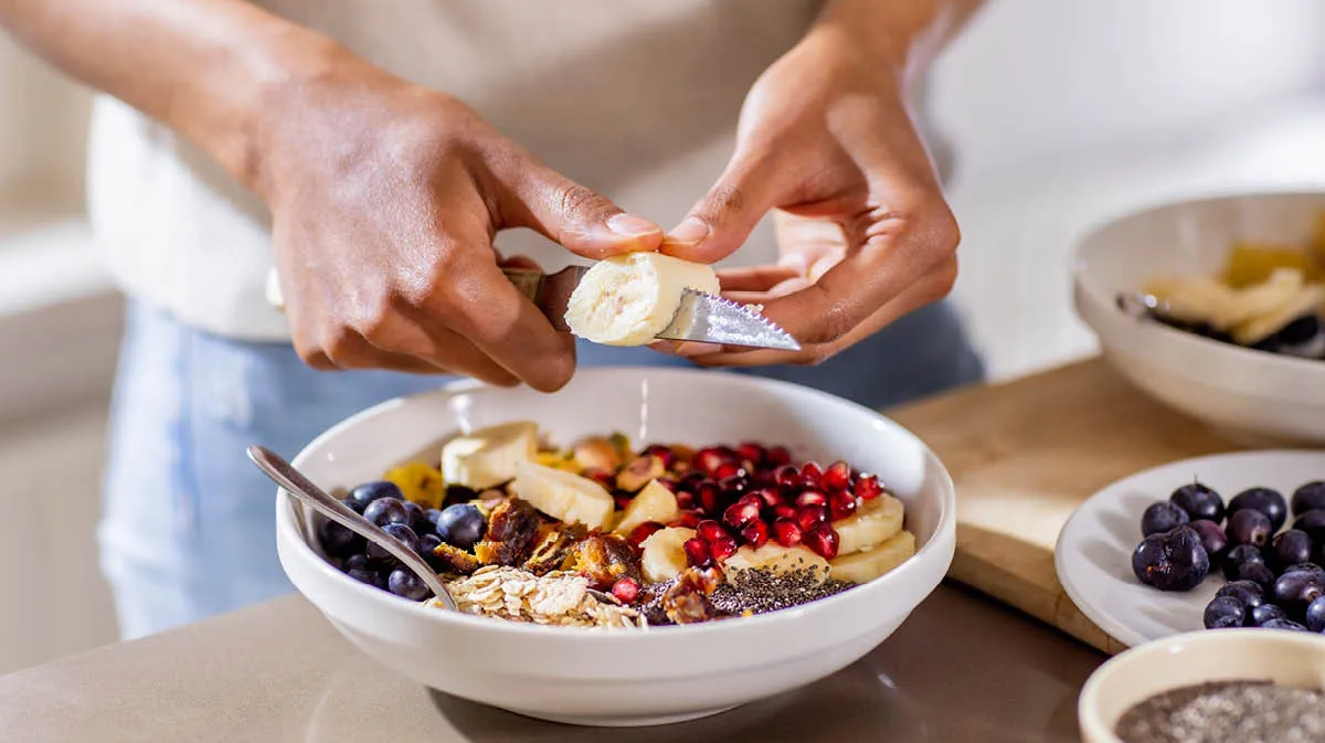 Person making a healthy fruit salad