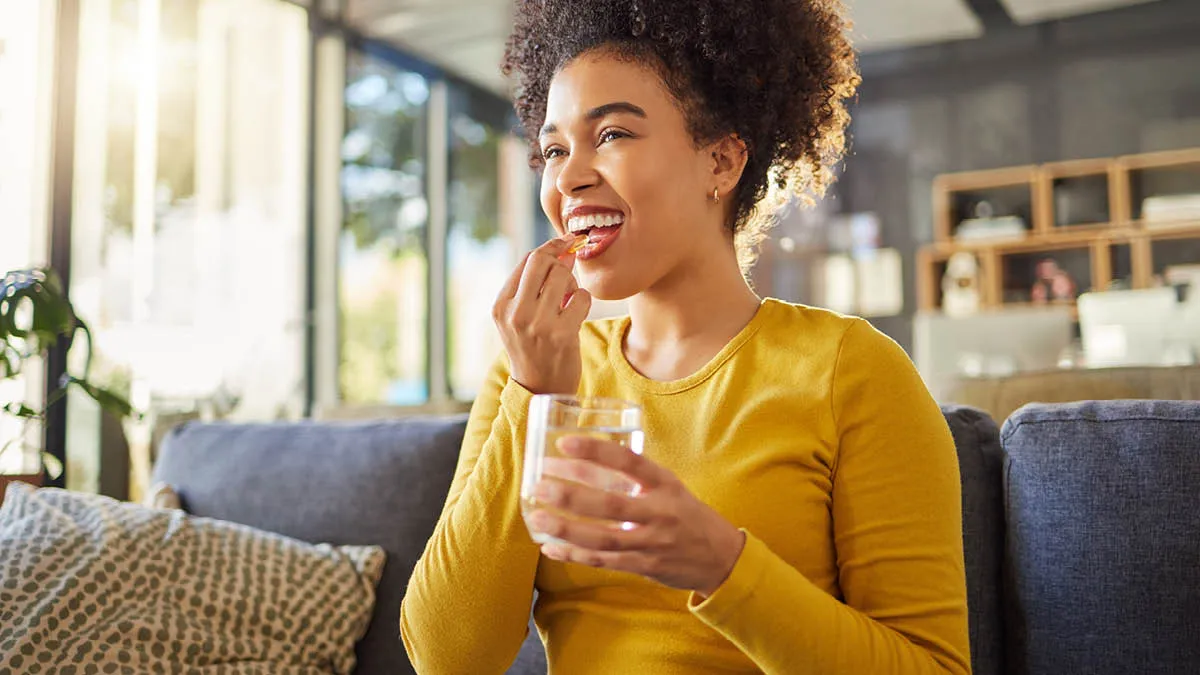 Lady taking a vitamin supplement