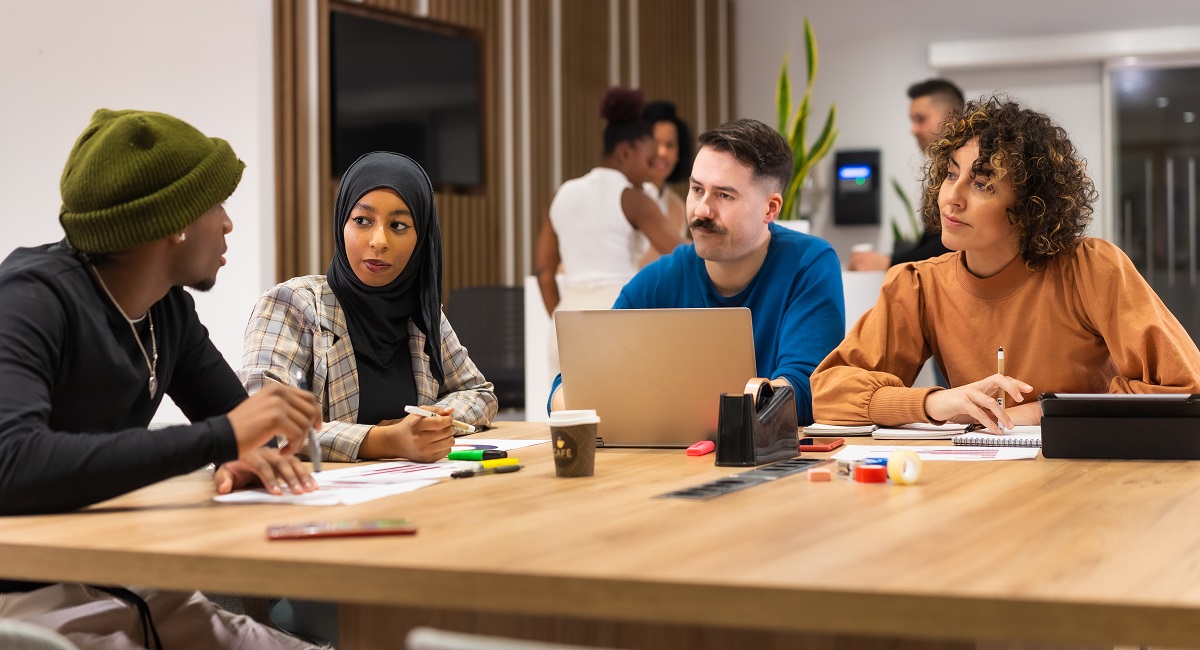 colleagues around a table at the office