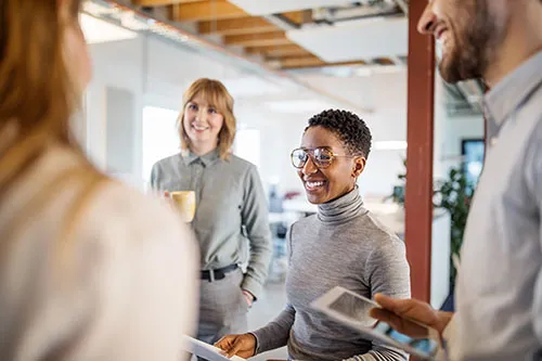 colleagues talking and laughing during meeting