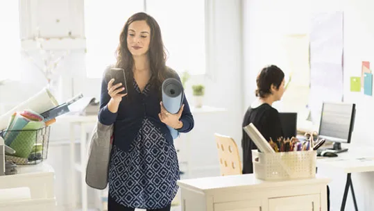 woman-carrying-yoga-mat-and-cell-phone