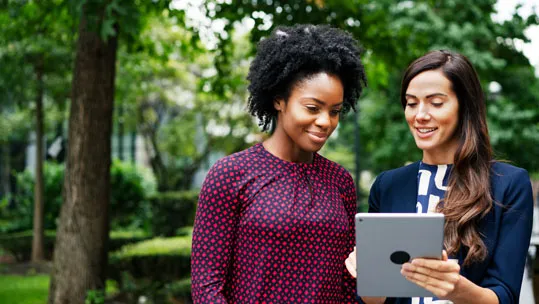 two-women-looking-at-tablet