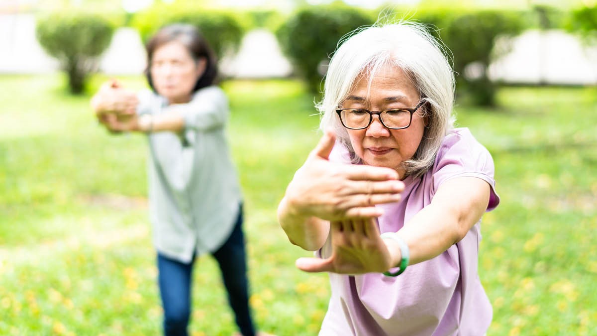Senior ladies in China practice mindful tai chi in an open space