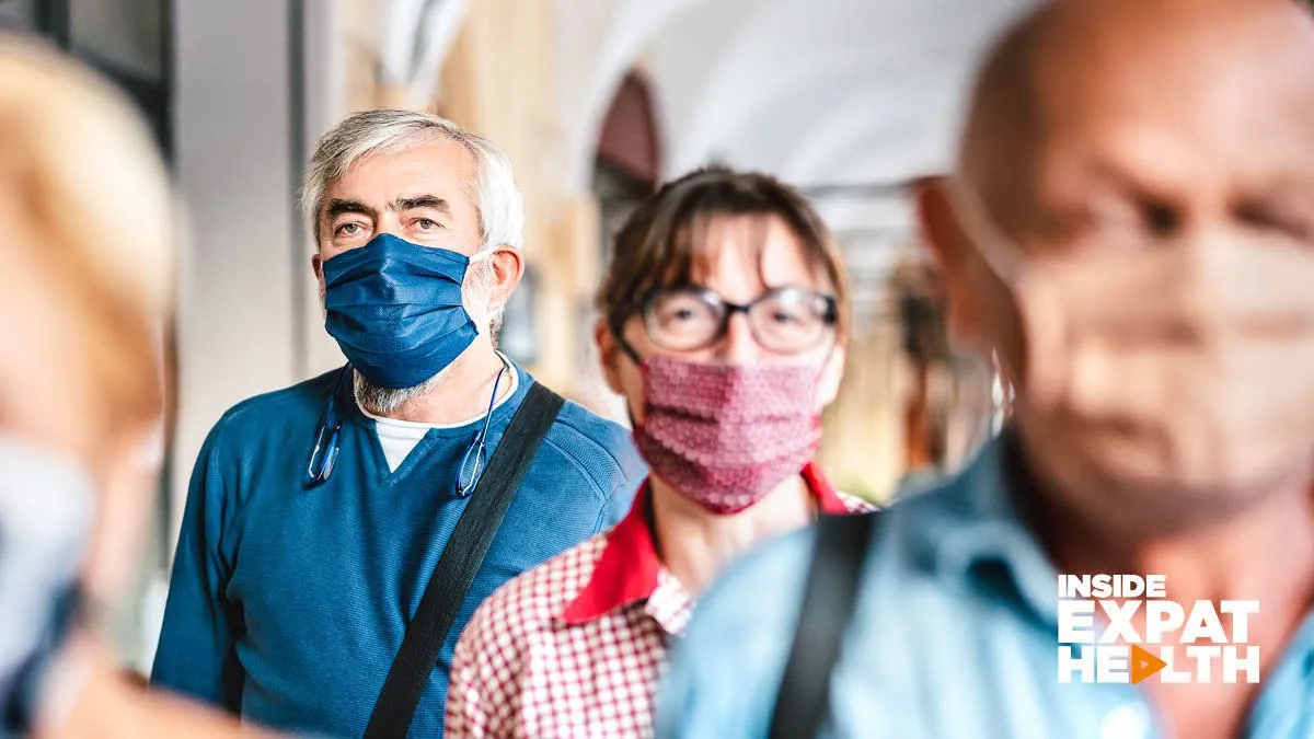 People queuing wearing face masks to protect themselves