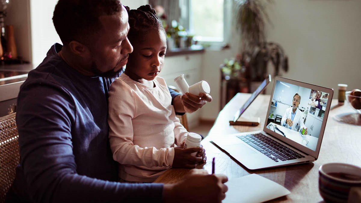 Man and young daughter consult a doctor via a telehealth service