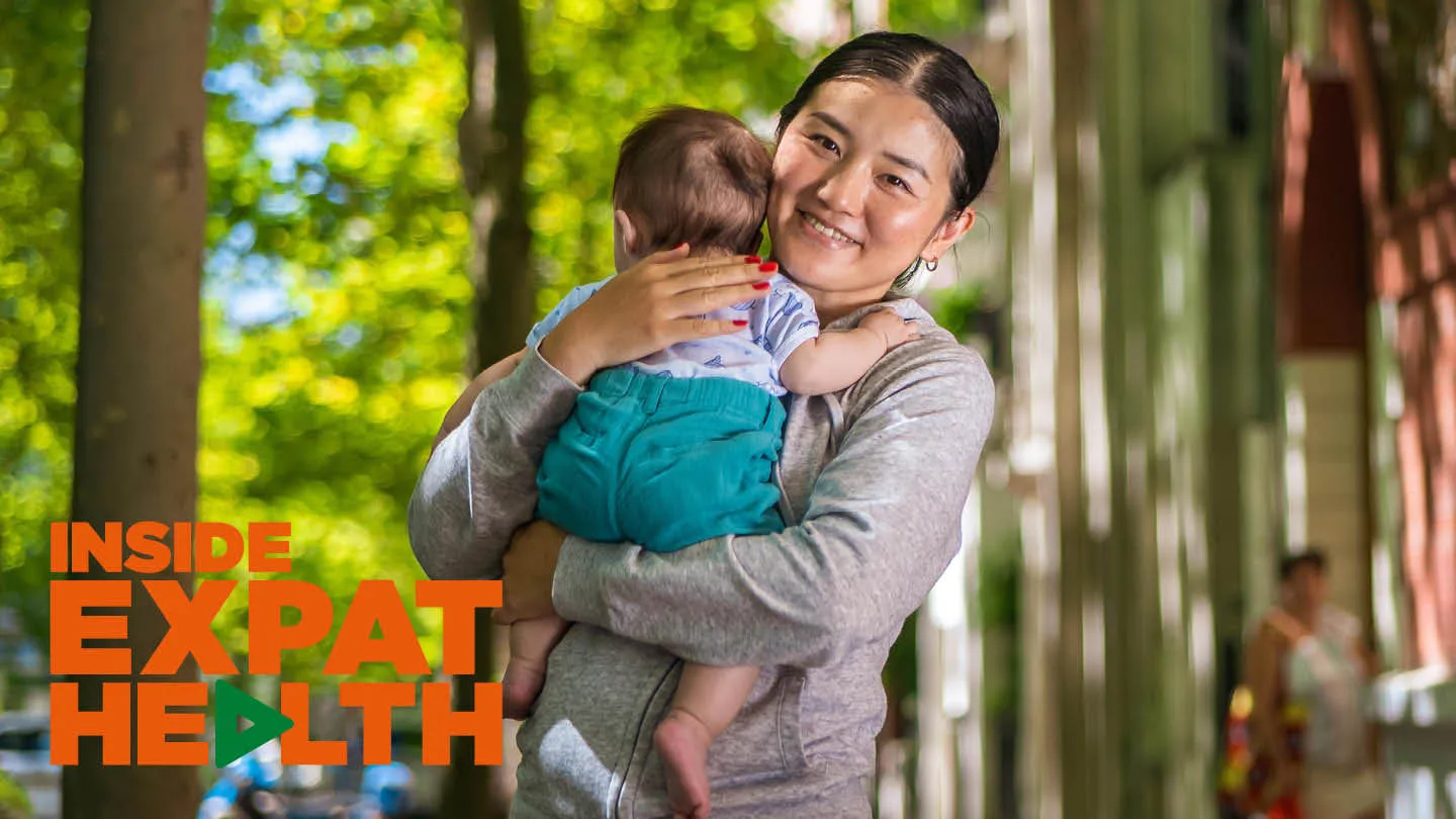 Japanese expat Akiko hugging her baby son in a Paris street