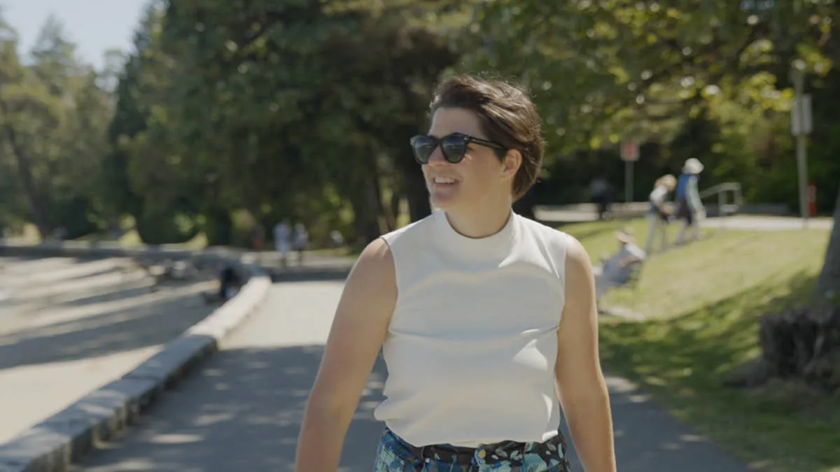 Australian expat Simone wearing sunglasses, smiling in the outdoors