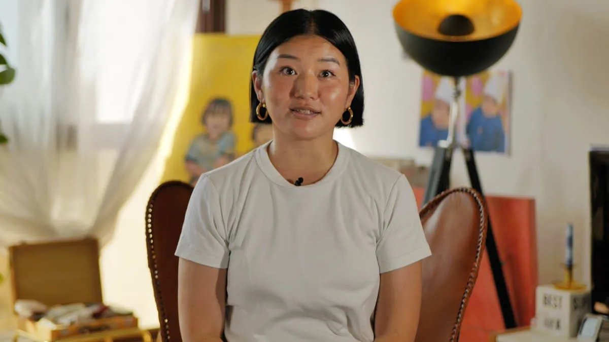 Japanese expat Akiko sitting in the living room of her home in Paris