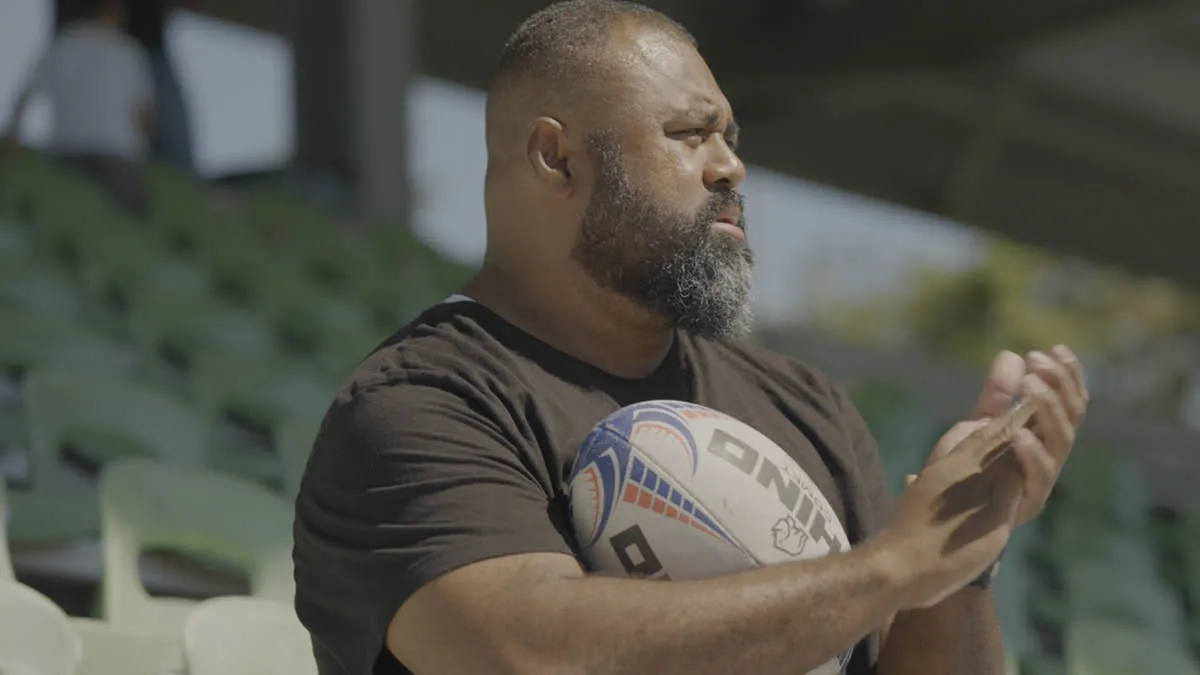 Close up of Fijian expat Pate holding a rugby ball