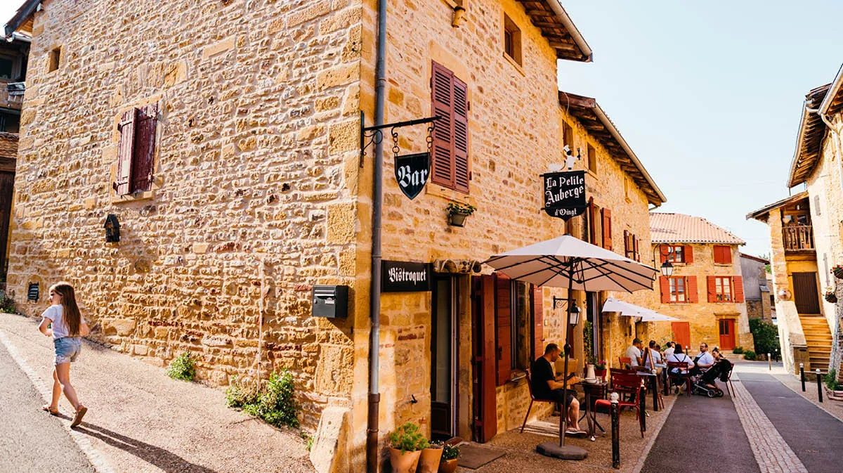 A beautiful old French street with a café with people sitting outside