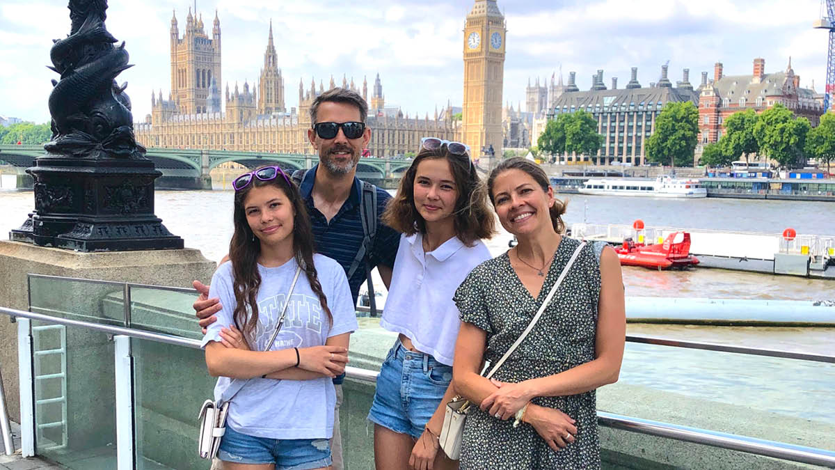 Mandy Haakenson posing by the river Thames with her husband and two daughters