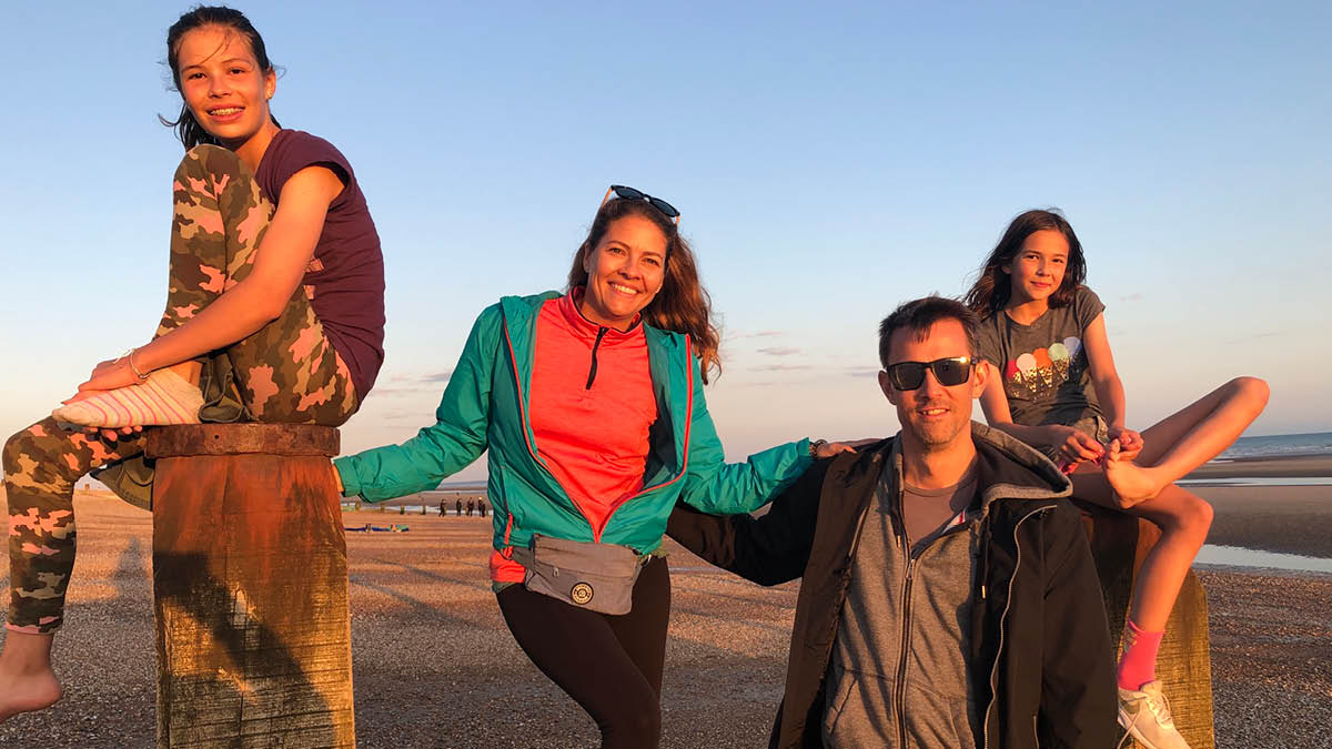 Mandy Haakenson with her husband and two daughters by the beach