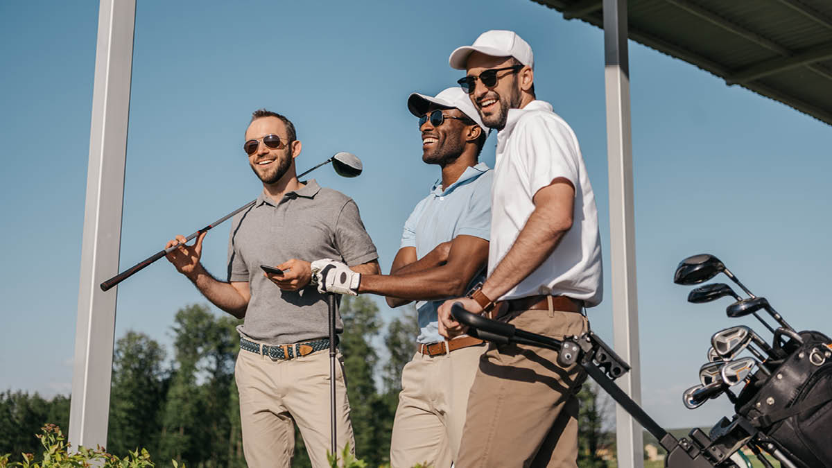 Three young men enjoying a round of golf in the sunshine