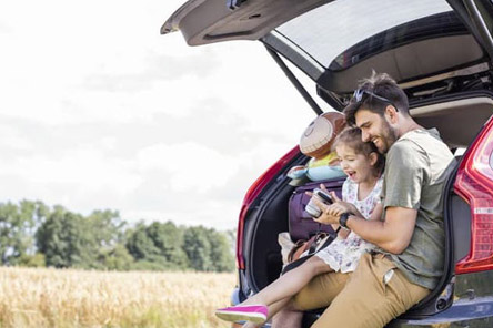 dad an daughter sitting in car